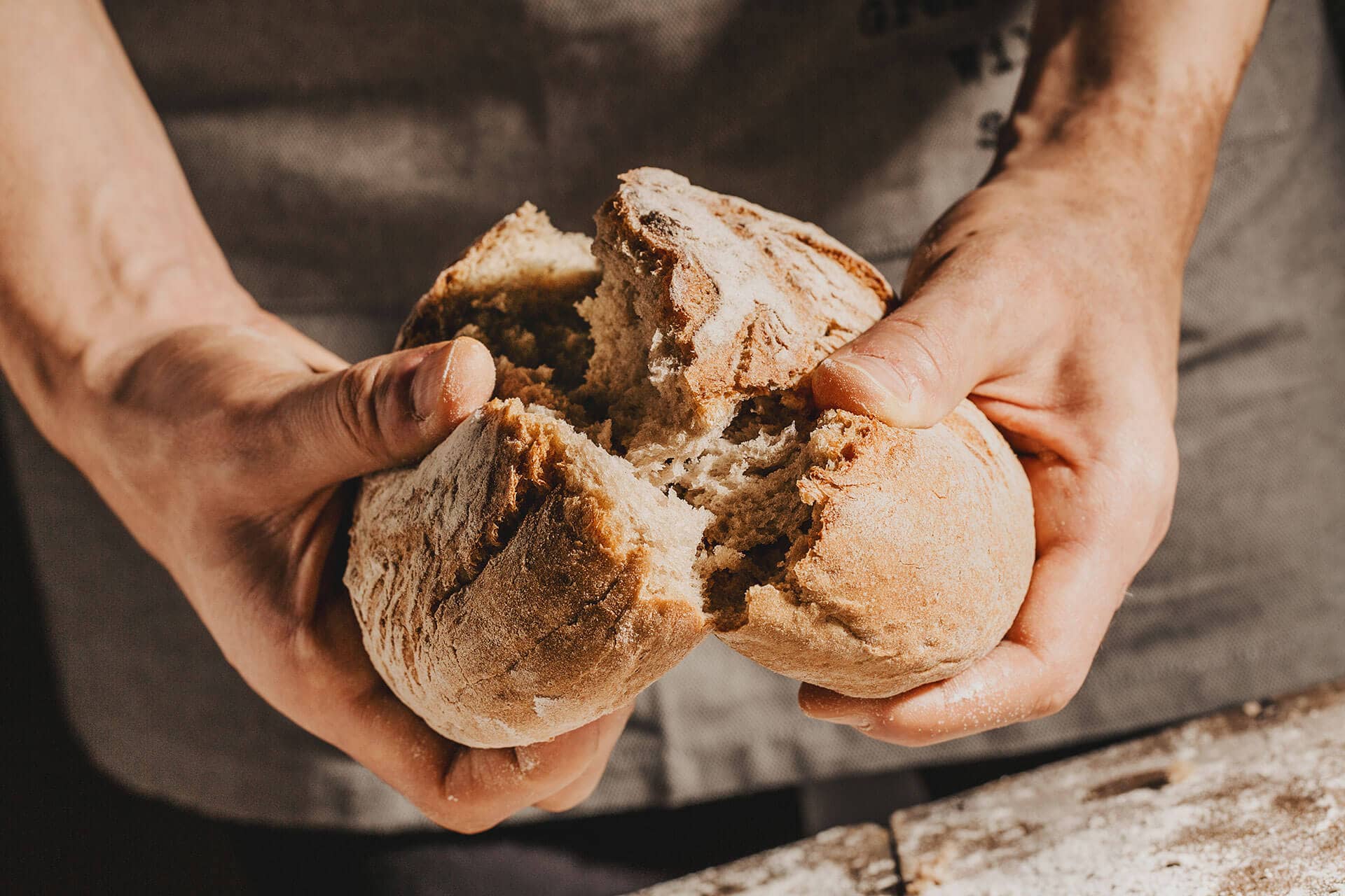 baker-or-chef-holding-fresh-made-bread-2WRSQ8J